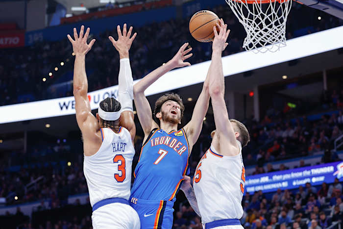 Dec 27, 2023; Oklahoma City, Oklahoma, USA; Oklahoma City Thunder forward Chet Holmgren (7) shoots between New York Knicks guard Josh Hart (3) and center Isaiah Hartenstein (55) during the second half at Paycom Center.